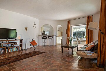 A living room with a couch and a flat screen tv