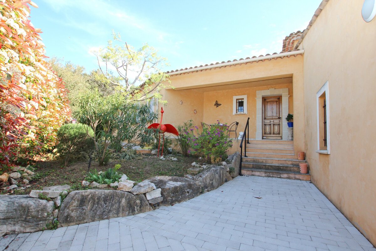A house with a red flamingo in front of it