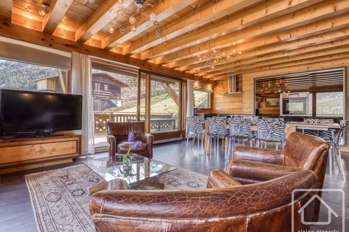 A living room with two chairs and a flat screen tv