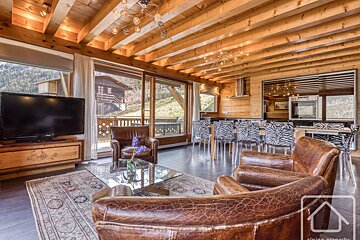 A living room with two chairs and a flat screen tv