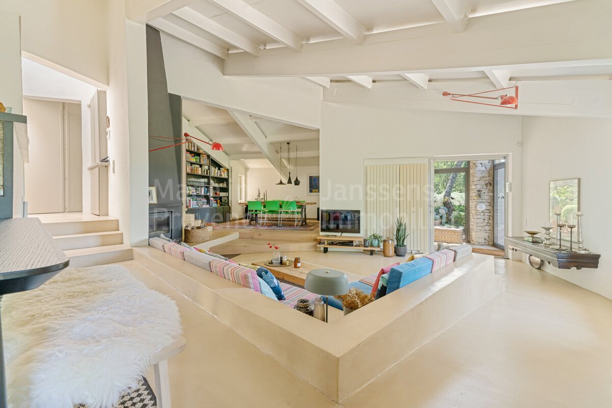 A living room with a couch and a television and a sign that says janssen