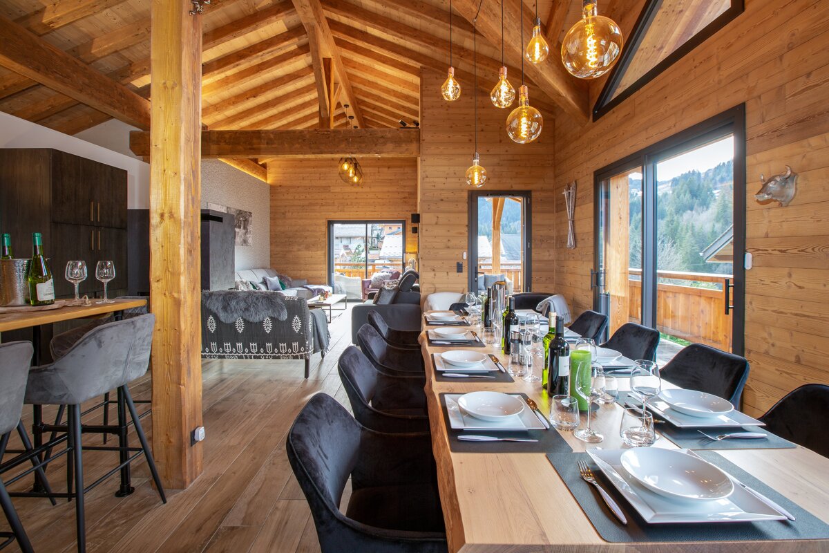A dining room table with plates and glasses on it