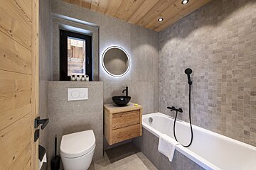 A bathroom with a toilet sink and a bathtub