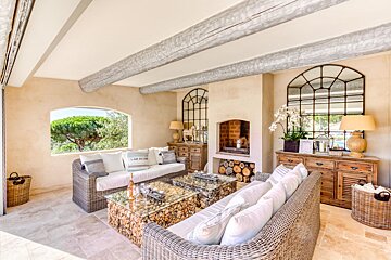 A living room with a fireplace and a couch that says i am beach