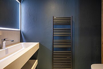 A bathroom with a towel rack and a sink