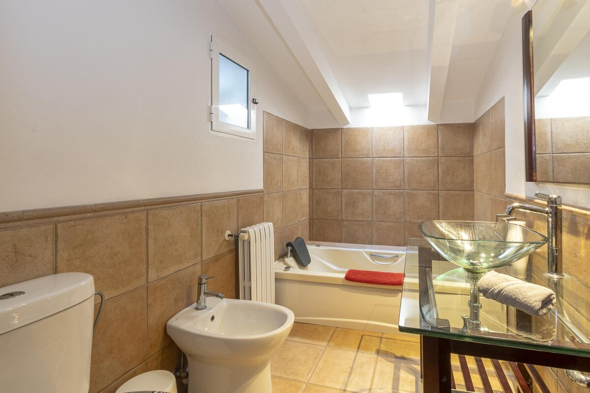 A bathroom with a sink a toilet and a bathtub