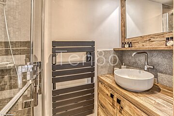 A bathroom with a sink and a towel rack that says temp80