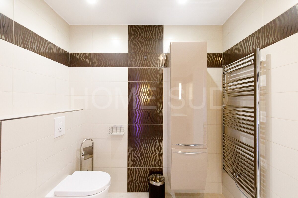 A bathroom with the word home on the wall