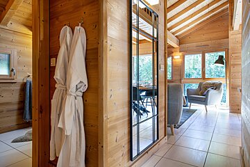 A wooden hallway with a large mirror on the wall
