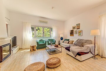 A living room with a couch and two chairs