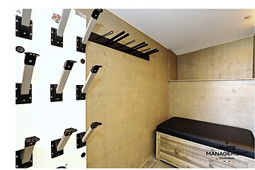 A wall with a bunch of hooks on it