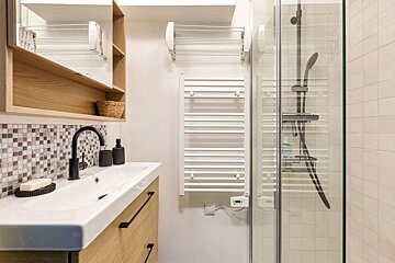 A bathroom with a sink and a towel rack