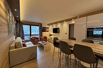 A living room with a couch a table and chairs