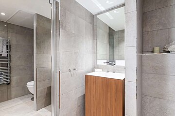 A bathroom with a toilet a sink and a mirror