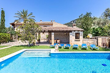 A house with a swimming pool in front of it