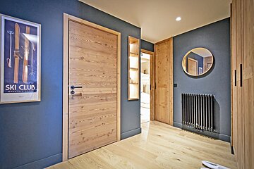 A ski club poster hangs above a wooden door
