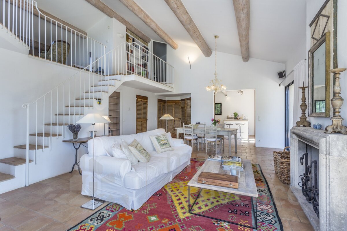 A living room with a staircase leading up to the second floor