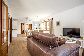 A living room with a brown couch and a flat screen tv