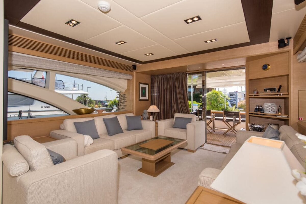 A living room on a boat with a couch and chairs