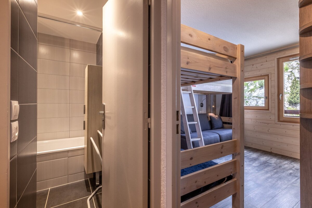 A bedroom with bunk beds and a couch