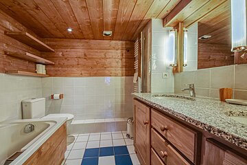A bathroom with a toilet a sink and a mirror