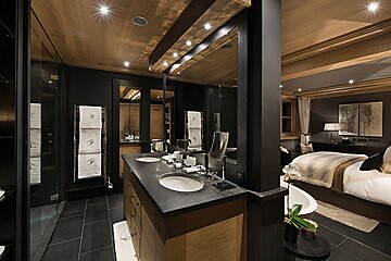 A bathroom with two sinks and a towel rack with the letter p on it
