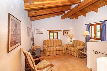A living room with a couch and two chairs