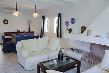 A living room with a white couch and a fireplace