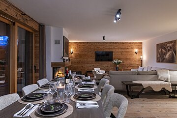 A dining room table with plates and utensils on it