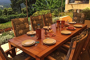 A wooden table with a bottle of wine on it
