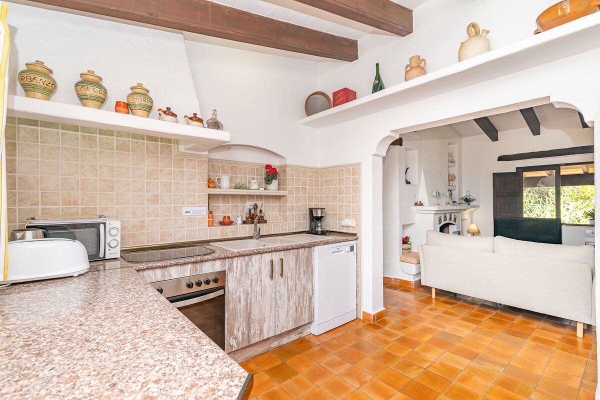 A kitchen with a dishwasher and a toaster oven