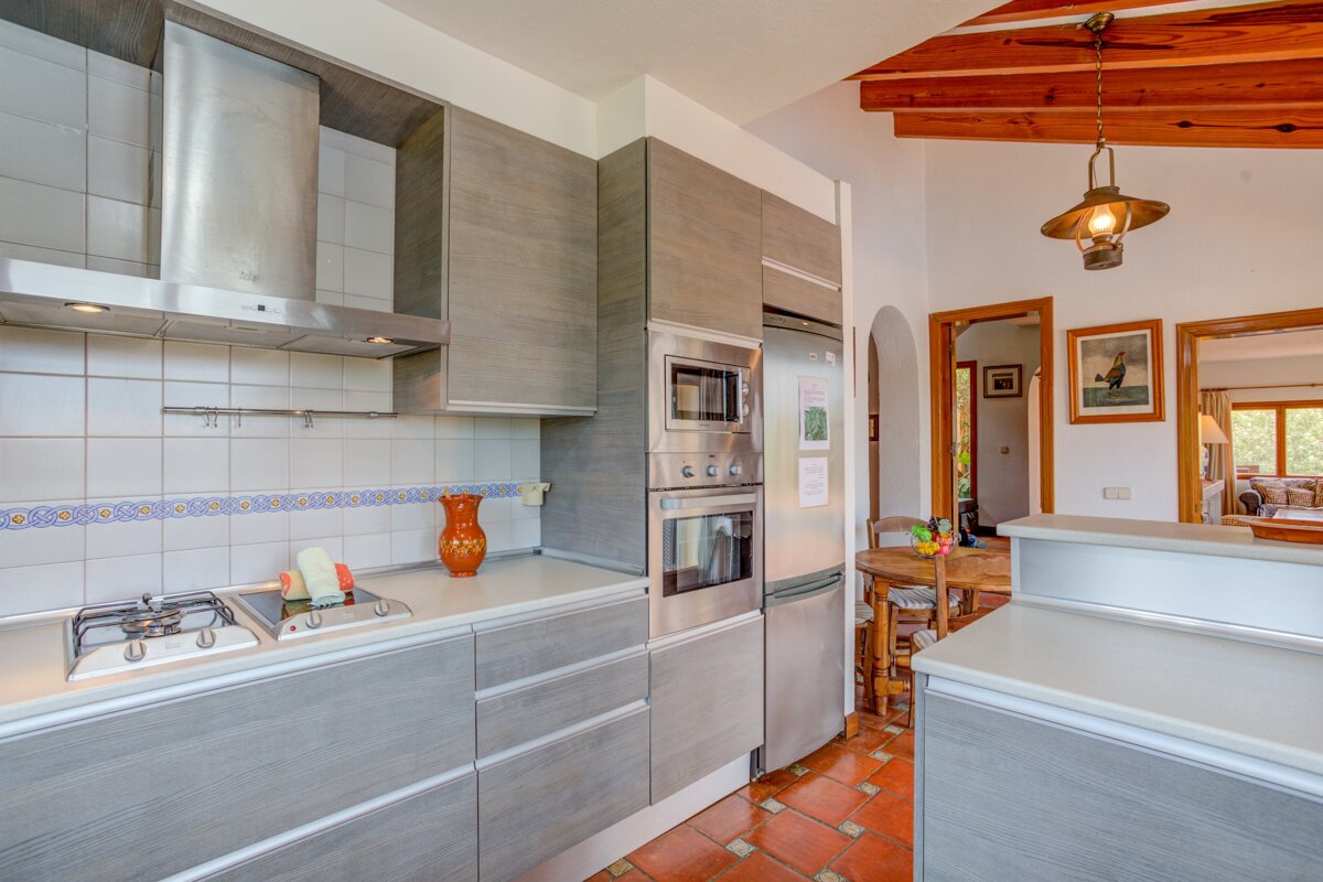 A kitchen with stainless steel appliances and gray cabinets