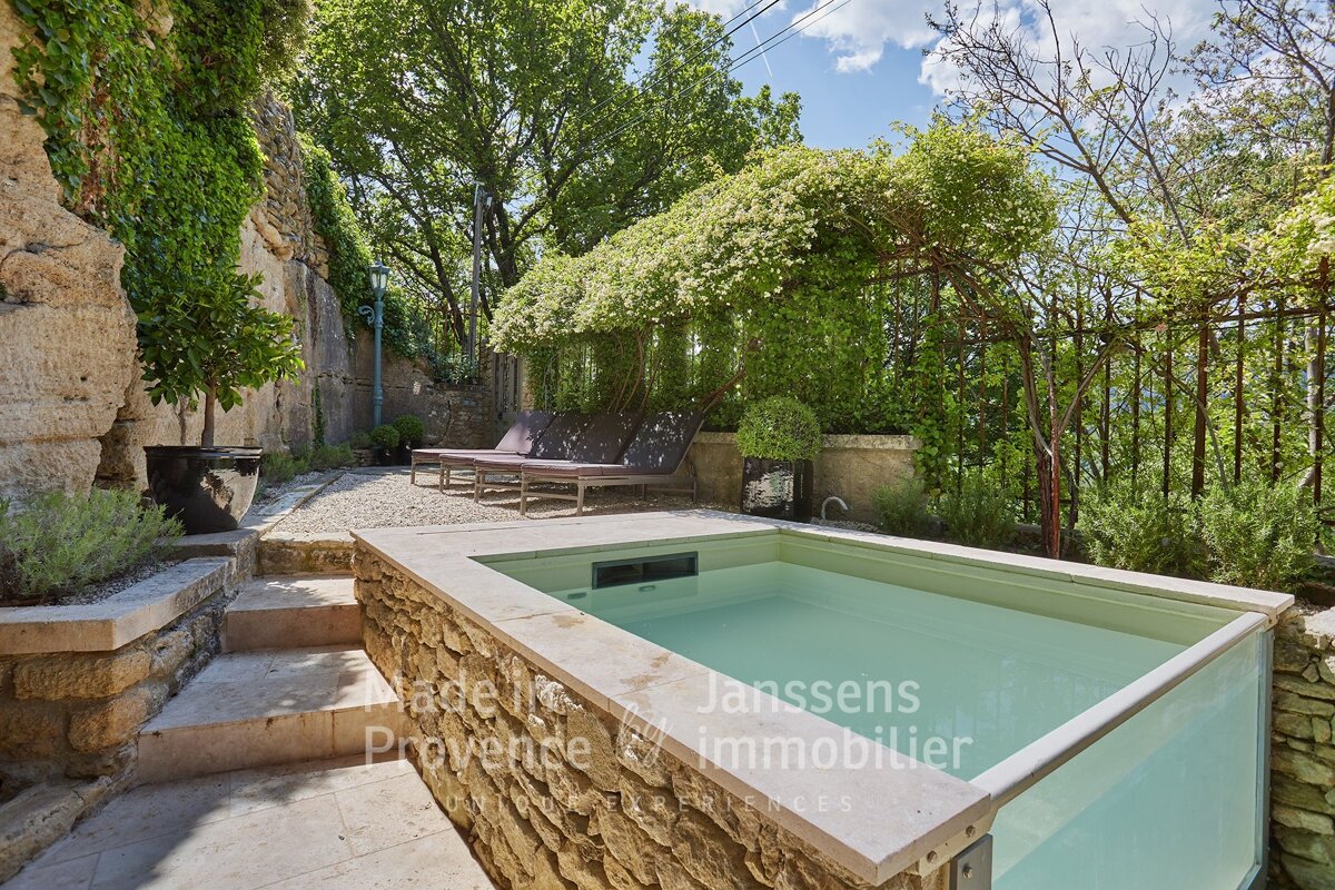 A swimming pool with a sign that says janssens immobilier