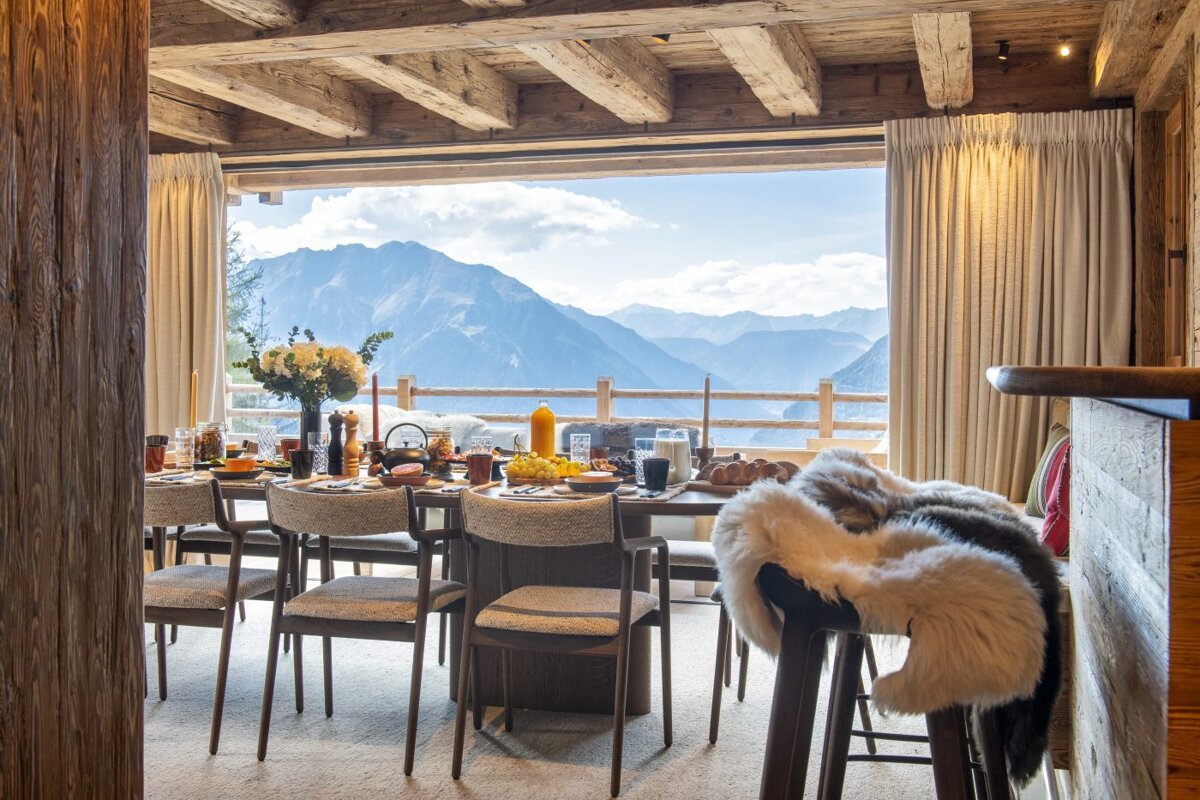 A dining room table with a view of the mountains