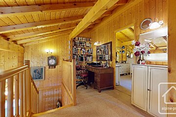 A wooden house with a clock on the wall