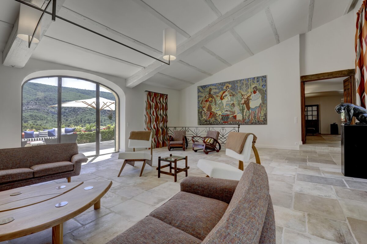 A living room with a large painting on the wall