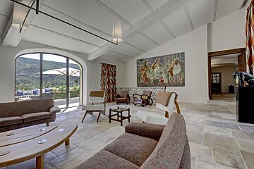 A living room with a large painting on the wall