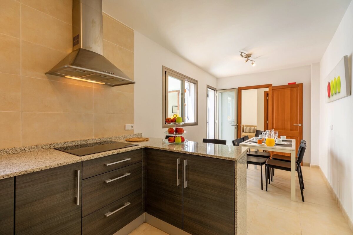 A kitchen with wooden cabinets and a stove top oven
