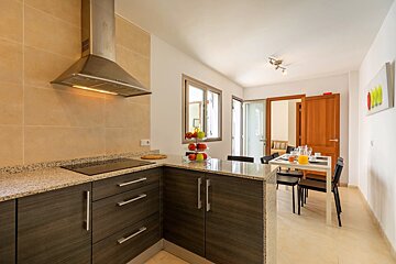 A kitchen with wooden cabinets and a stove top oven