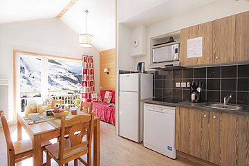 A kitchen with a dishwasher and a microwave