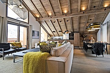 A living room with a couch and a yellow blanket