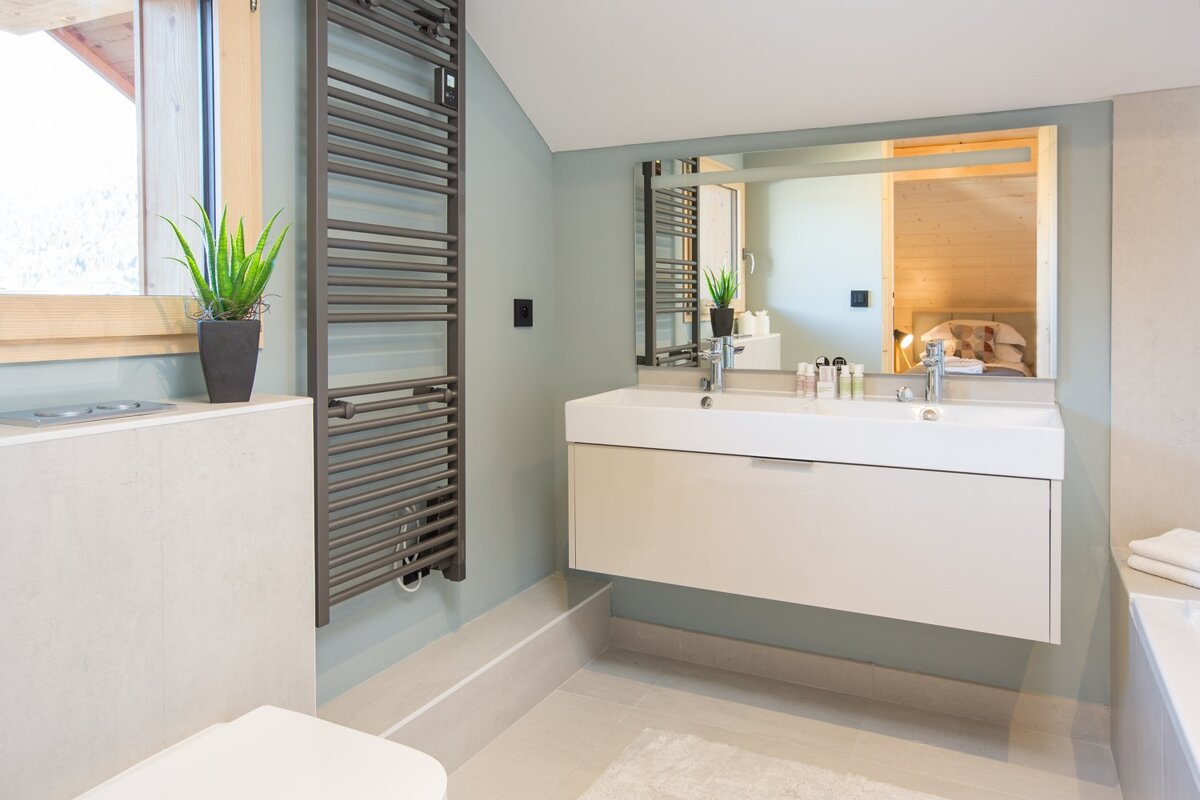 A bathroom with a sink and a towel rack