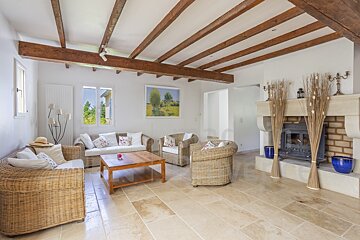 A living room with wicker furniture and a fireplace