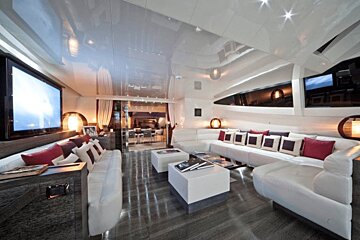 A living room with white furniture and a flat screen tv