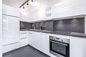 A kitchen with white cabinets and an electrolux oven