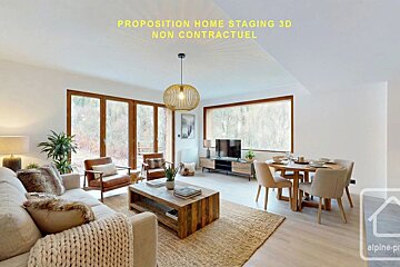 Cozy, modern open-plan living and dining room with wood furniture, warm neutral tones, and large windows showing a scenic view.