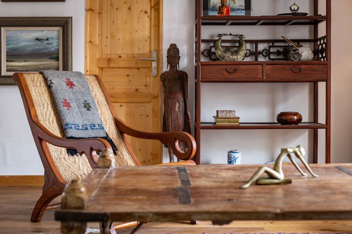 A chair with a blanket on it has a greek key pattern on it