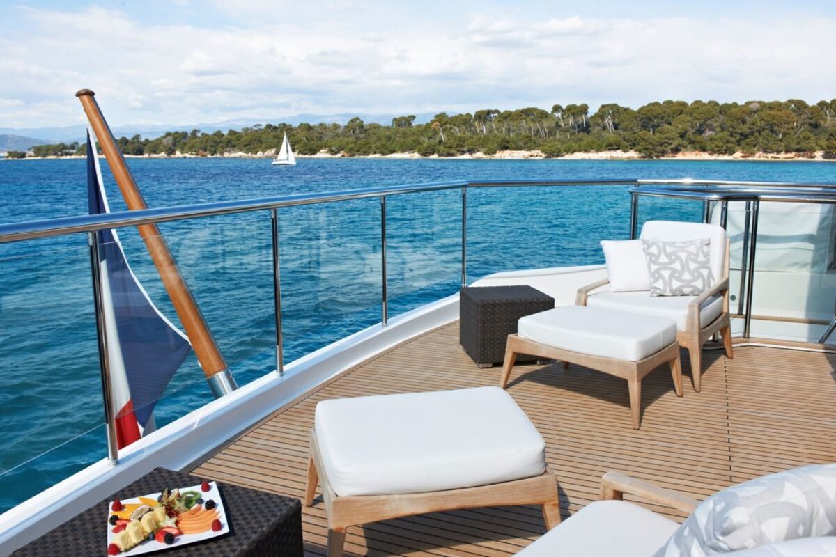 A plate of fruit sits on the deck of a boat