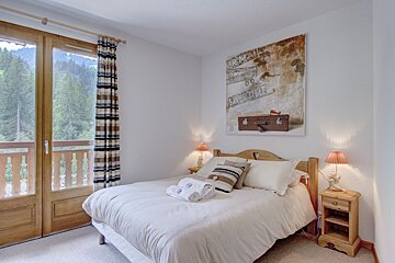 A bedroom with a painting on the wall that says save time