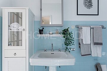 A bathroom with a sink and a cabinet with the word home on it